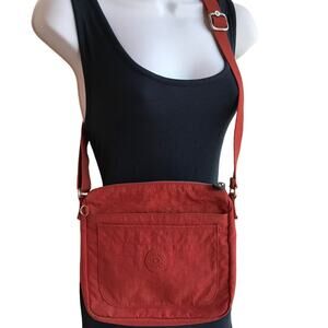Kipling Coral Orange Crossbody Bag with Multiple Pockets and Zips